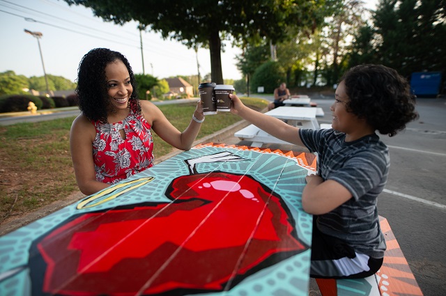 Mother and child enjoy painted picnic table