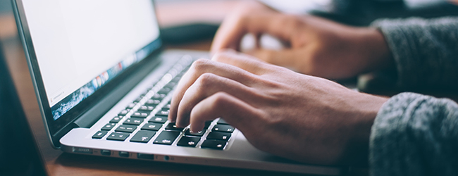 Person Typing on Keyboard