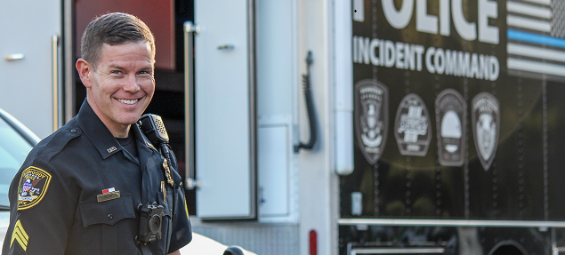 Officer in front of command truck