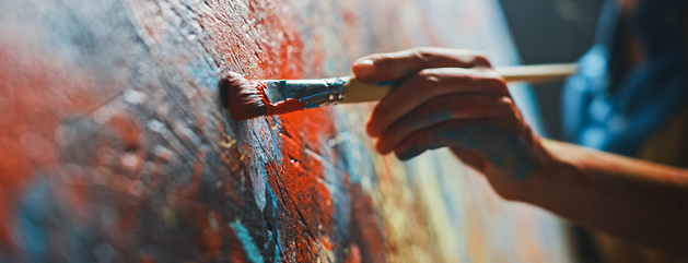 Artist's hand painting on canvas