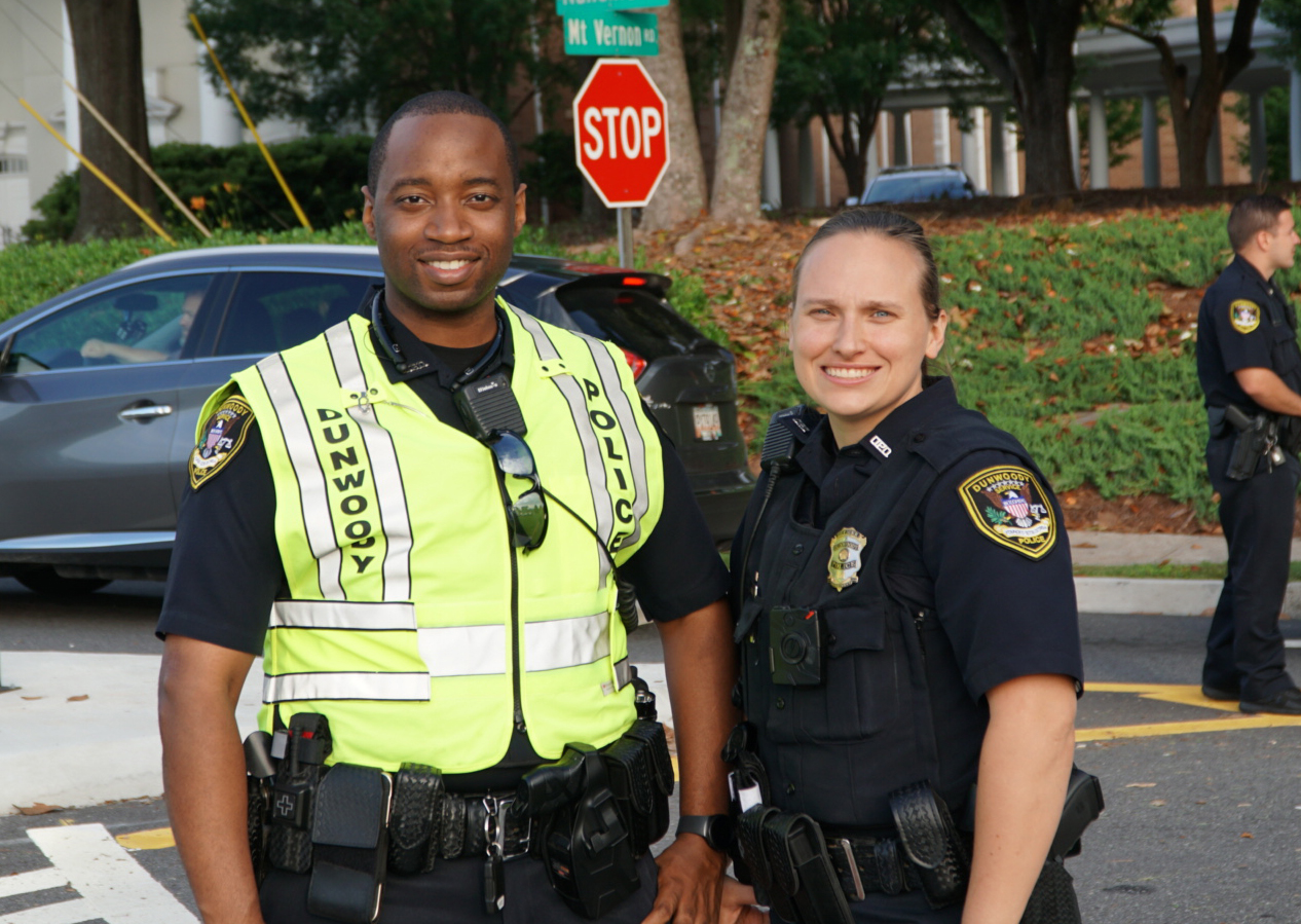 male and female officer smiling