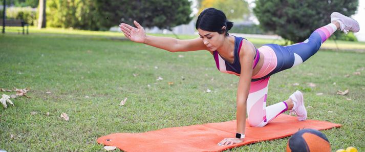 Instructor leading outdoor yoga class