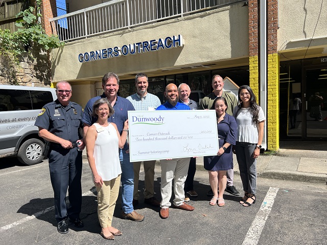 Dunwoody Council Members and Police Chief and Corners Team Check Presentation